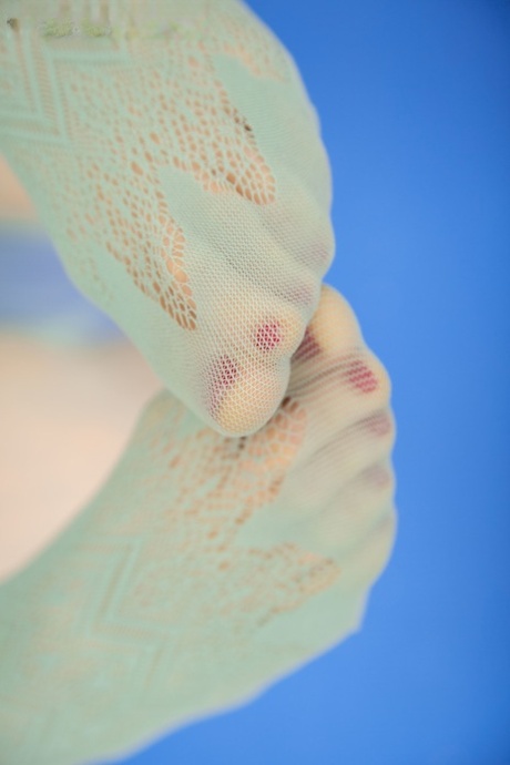 Dashing in her long crotchless pantyhose, Danna is playing with herself while giving birth.