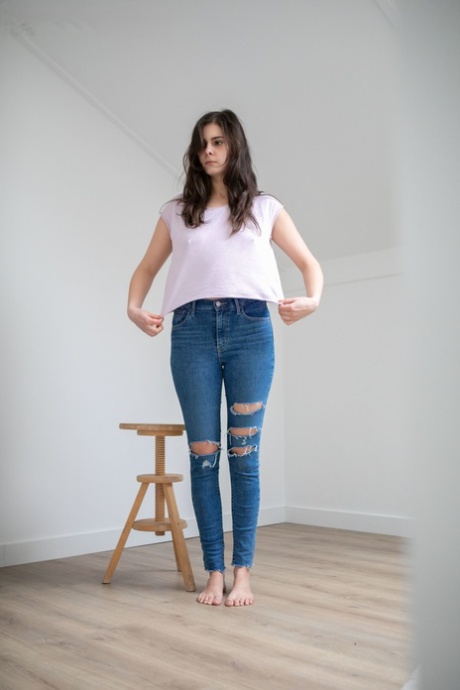 While putting on her clothes, Brunette Celine displays her prominent chest and arches.