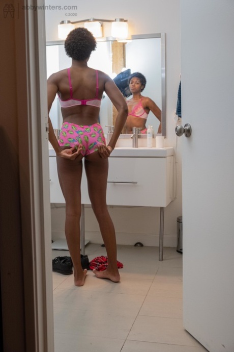 Ashlee L wears short hair in the bathroom and undies while her hair is a delicate ebony color.