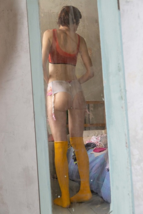 Closeted Australian girl Nikolina wears tight jeans and yellow boots for her appearance.