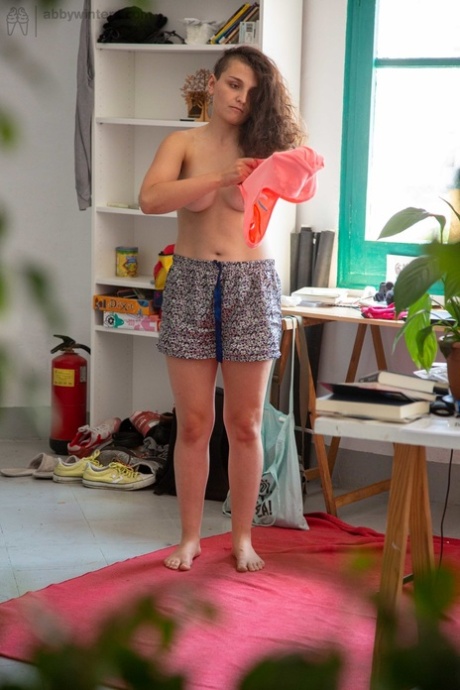 Prior to wearing clothes, Pascal displays her unaltered tits and fuzzy pussy.