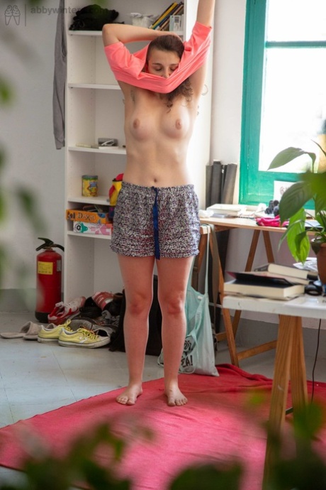 While Pascal displays her unobtrusive buttock muscles, she also demonstrates her fuzzy pussy before wearing her clothes.