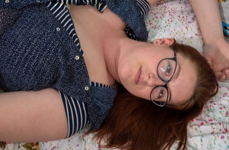 With her oversized breasts and toys with her bush, Breanna exposes her big features as a cheeky redhead.