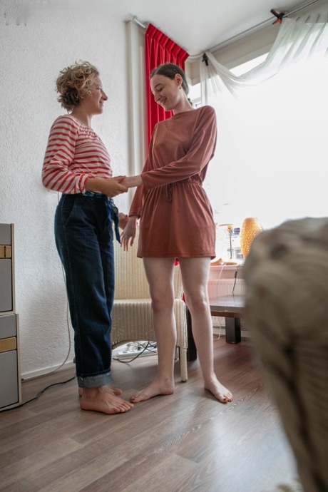The young sweethearts named Manon and Zina B are seen dressing indoors with each other.