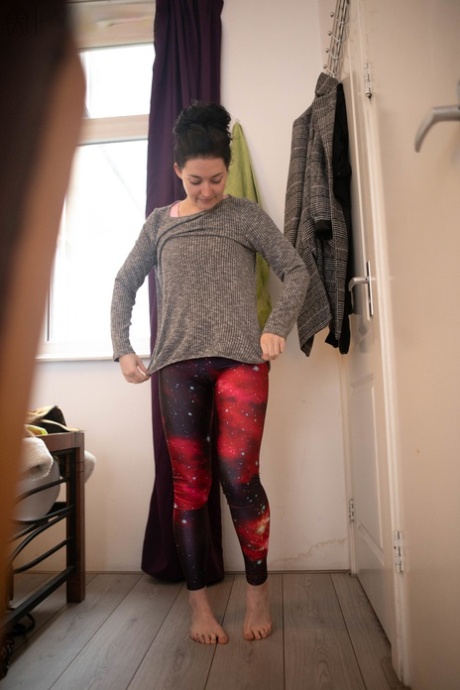 Spunky amateur model Marine displays her tight buttocks as she gets dressed.