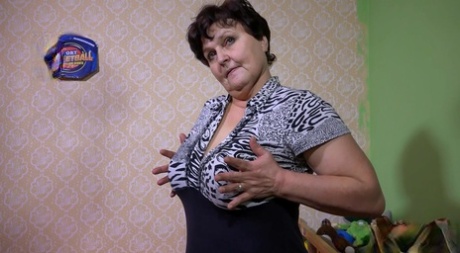 Old woman with huge saggy breasts Brigita masturbates in her room.