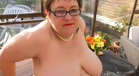 Rita, despite having short hair and glasses on, displays her large chest area while masturbating.