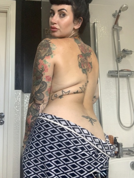 Cherrie Pie, who has tattooed fat, displays her oversized bust while bathing.