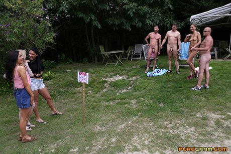 Lovely Clothed Female Students Blow Off A Nudist Colony Outdoors