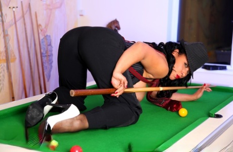 Danica Collins, the curvy woman, exposes her billiards equipment and bush on top of a billiards table.