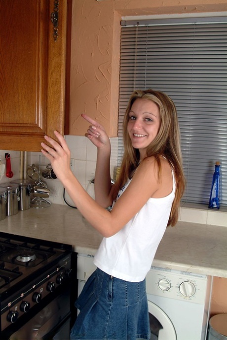 In a hot kitchen striptease, Kim B, a petite teenager, was seen spreading her meaty pussy.