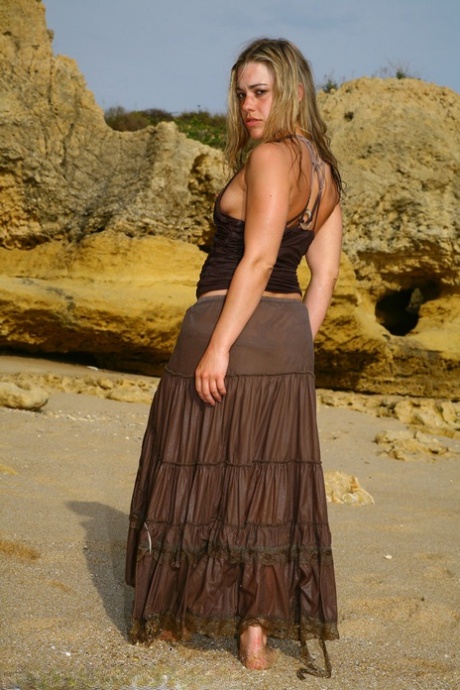 The sexy British model, Tammy Oldham, is seen on a sandy beach engaging in self-pleasure.