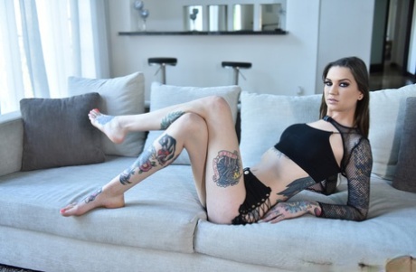 Rocky Emerson, a tall brunette with tattooed feet, uses them to show off her sexy curves.