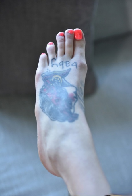 Rocky Emerson, a tall brunette looking for heights with tattooed feet, uses them to get in the way of her penis.