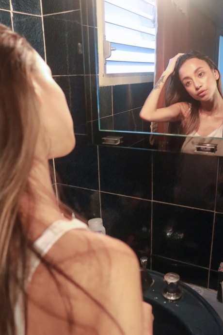 Camila Luna, a beautiful young girl, exhibits her stunning chest and booty while smoking.