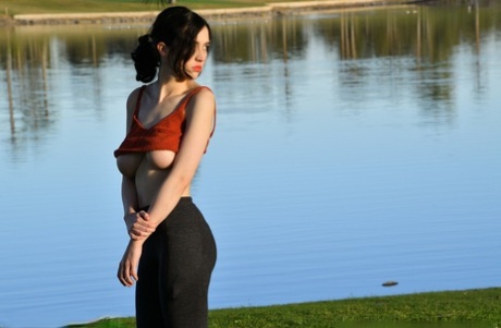 Exposed Giulia displays her ample bust while donning yoga pants for pranks outside.