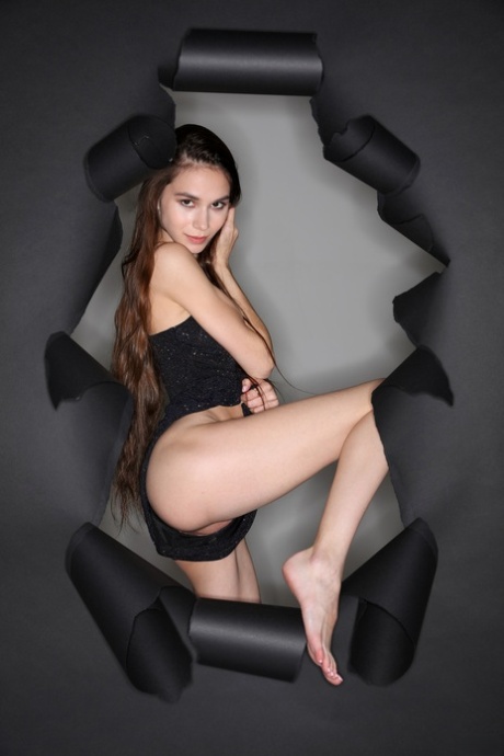 A photograph depicts Leona Mia, a brunette Russian woman with skinny legs and small buttocks.