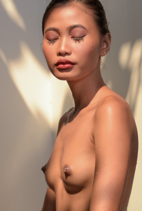 Erotic Asian teen Hiromi exposing her slender oily body poolside