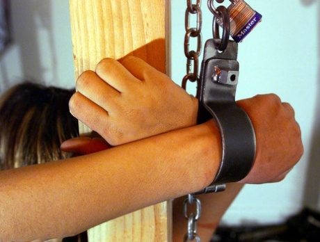 The Miss Fever, who wears a corset and gag Passion, is joined to a wooden chair by being chained.