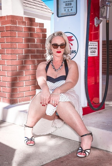 In the meantime, Dee Siren flaunts her obese buttock muscles while posing at a gas station with retro pinup MILF.