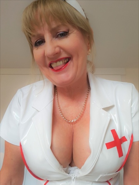 A mature nurse named Lorna Blu shows off her large buttocks and crotch in a solo performance.