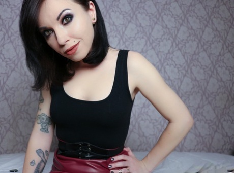 An exaggerated brunette named Lisa Dove strips her latex skirt and then uses the pressure off of herself, washing away her toes with her fingers.