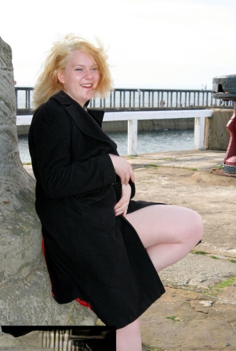 At times, the blonde BBW Bhala Sada appears in public only wearing a black coat.