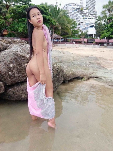 Asian amateur, Kiki Asia flaunts her sexy figure in a bikini while lounging on the beach.