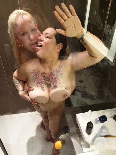 While taking a shower, Fatty Kandi Karter is approached by another blonde MILF who grabs her big tits.