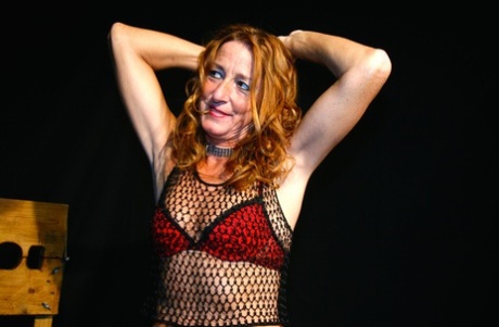 Redheaded MILF Kyra Nylons Flaunts Her Titties Through A Fishnet Shirt