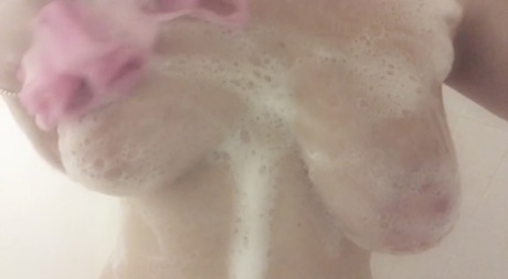 Amateur walker and groomer Natasha teases her large natural curves with her loose tummy in the shower.