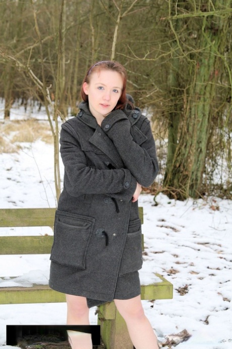 Posing in the snow: Sexy amateur MILF posing with coat and running shoes