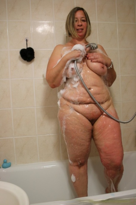 A photograph of a Blonde MILF Shooting Star shows her naked and heavy body in the shower.