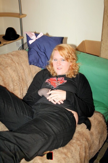 In the presence of a redheaded fatty, she removes her sweatshirt and exposes her belly button in a black bra.