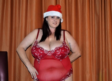A horny mom named Kimmie Kaboom flaunts her curvely breasts in an alluring Christmas cape.
