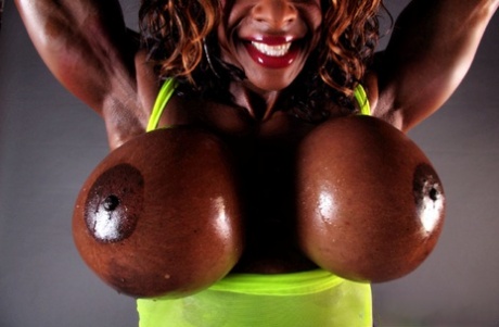 Muscular ebony-haired, massive melons are being displayed by the muscular Yvette Bova as she lifts her weights.