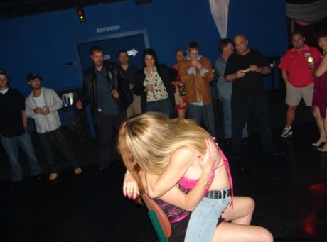 In the nightclub, inexperienced partners engage in sexual activities by stripping and licking each other's pussies.