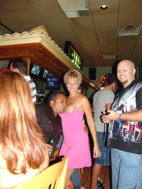 At the bar, sensual wives exhibit their oversized breasts while partying.