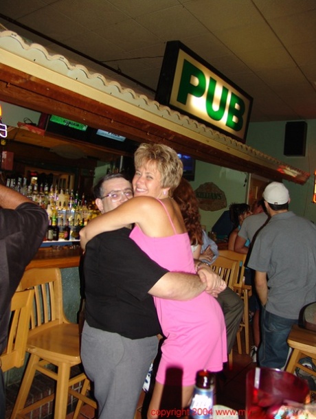 The bar's hunky, full-grown wives are all smiles as they proudly display their ample breasts.