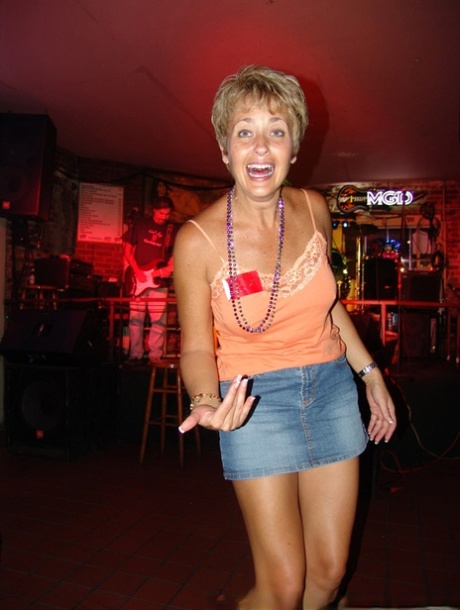 Tracy Lick, an amateur swinger with big tits, showcases her abilities at a night bar.