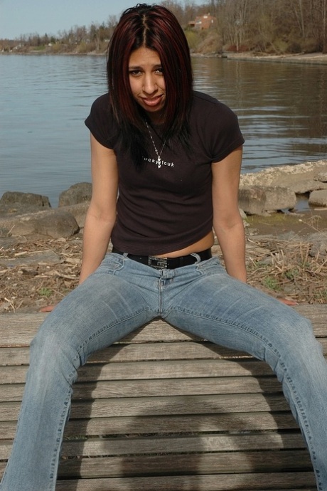 Becky Parker, the feisty young lady, exposes her large buttocks by taking off her jeans.