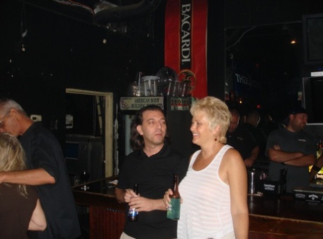 She is showcased with big boobs by amateur swingers at a wild party at the bar.