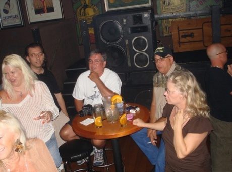 In the bar, amateur swingers flaunt her massive breasts during a wild celebration.