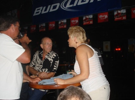 At a party in the bar, novice swingers exhibit her sizable breasts with their fullest appeal.