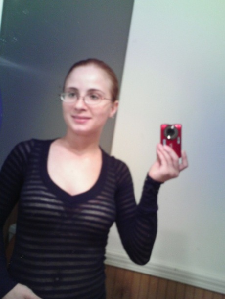 As a leaning young woman, Hannah takes stunning selfies with her natural big tits in the mirror.