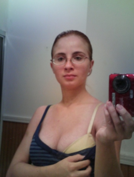 Nerdy teen Hannah takes selfies of her natural big tits in the mirror