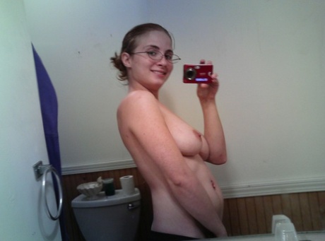 Nerdy teen Hannah takes selfies of her natural big tits in the mirror