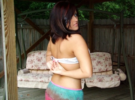 Exhibiting her juicy breasts and exposing herself outside, Roxy Sapphire removes her bra.