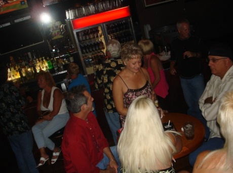 An adult male with an impressive rear end and big thighs exhibits her tattooed body in the club.