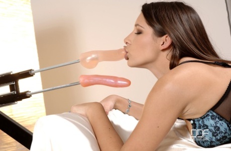 Zafira, a Hungarian brunette, uses a dildo machine to fill her twat.